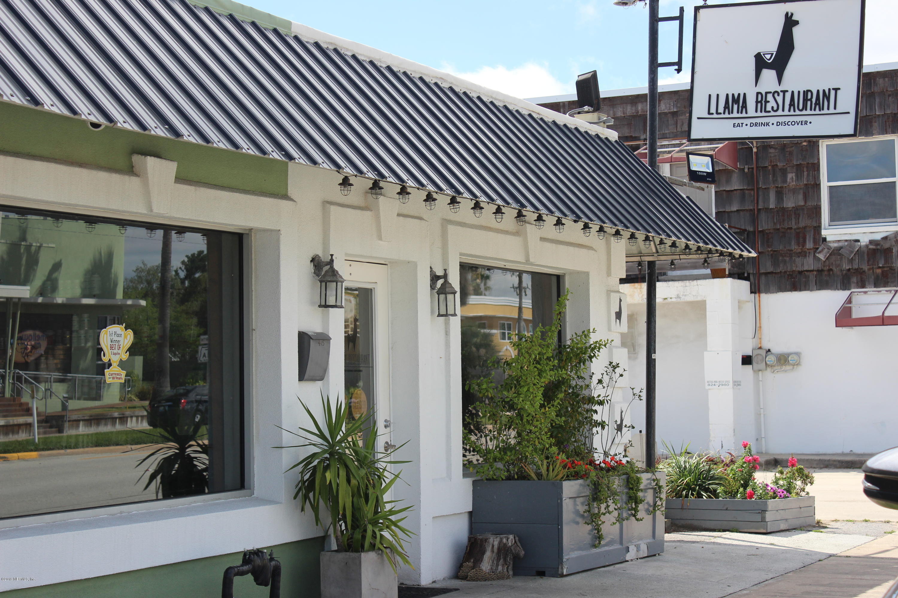 32 Dolphin Drive St. Augustine, FL 32080 - Photo 40 of 43 a front view of a house with a garden
