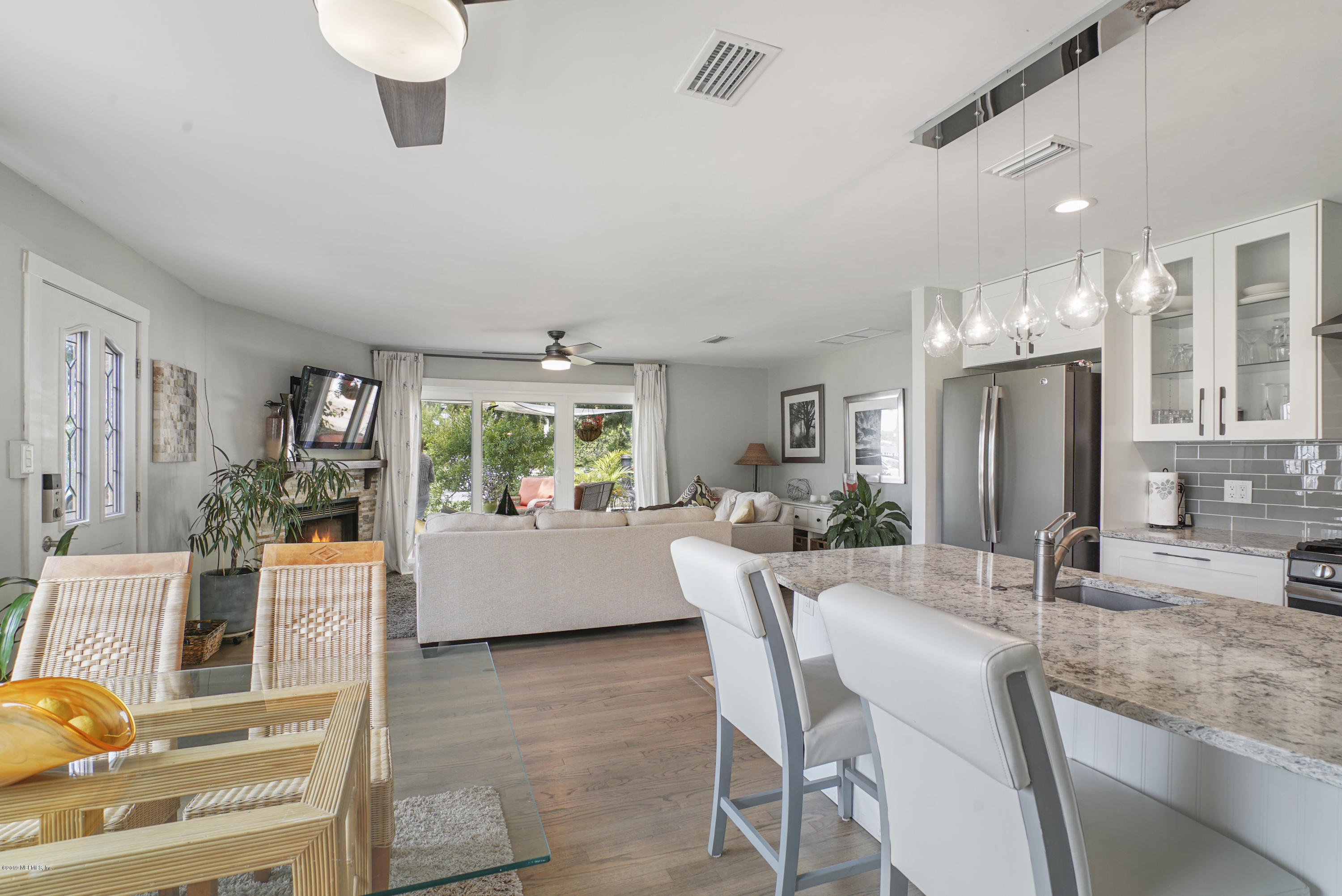 32 Dolphin Drive St. Augustine, FL 32080 - Photo 8 of 43 a view of a dining room with furniture a kitchen and chandelier