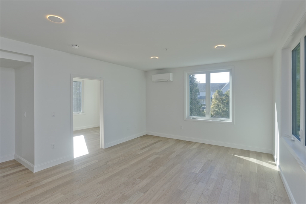 107 Williams Street Northampton, MA 01060 - Photo 11 of 17 an empty room with wooden floor and windows
