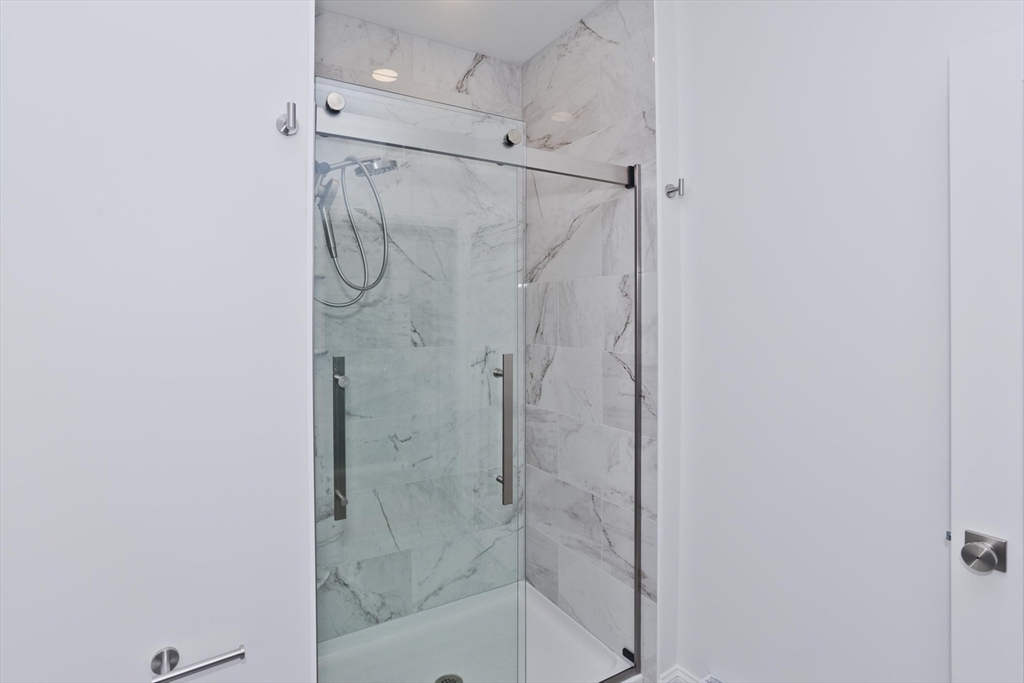 107 Williams Street Northampton, MA 01060 - Photo 8 of 17 a bathroom with a glass shower door