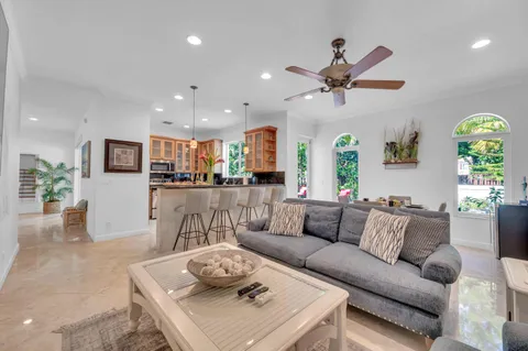 a living room with furniture kitchen and a table