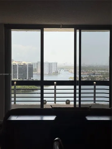 a view of a balcony with furniture and city view