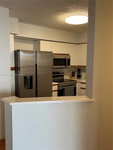 a living room with furniture a rug and a table