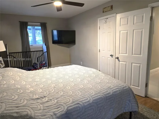 a bedroom with a bed and a flat screen tv
