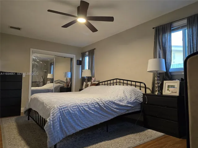 a bedroom with bed and window