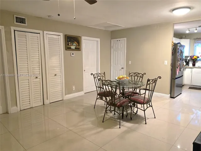 a dining room with furniture and entryway