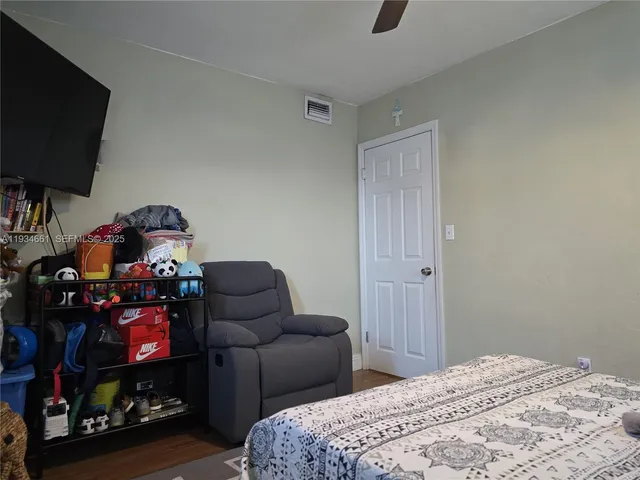a bedroom with furniture and a flat screen tv