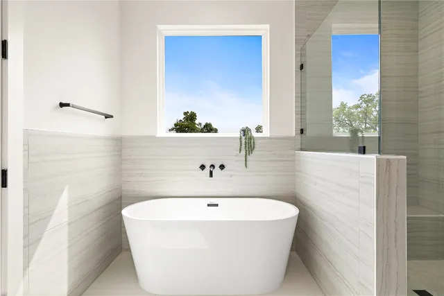 a bathroom with a tub and a shower