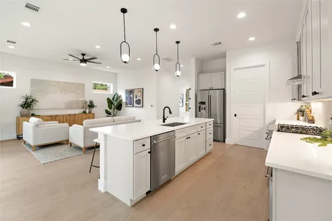 a living room with furniture and kitchen view