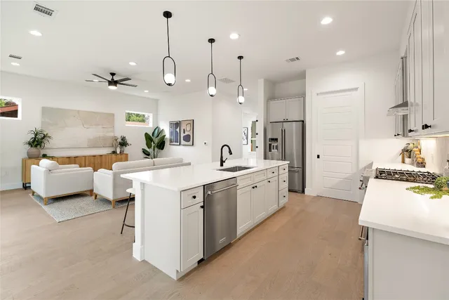 a living room with furniture and kitchen view