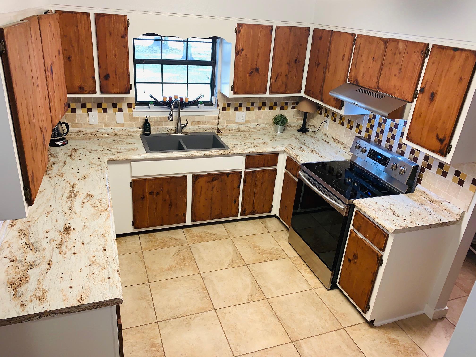 5846 Dairy Road Baker, FL 32531 - Photo 16 of 68 a kitchen with a stove a sink and a microwave