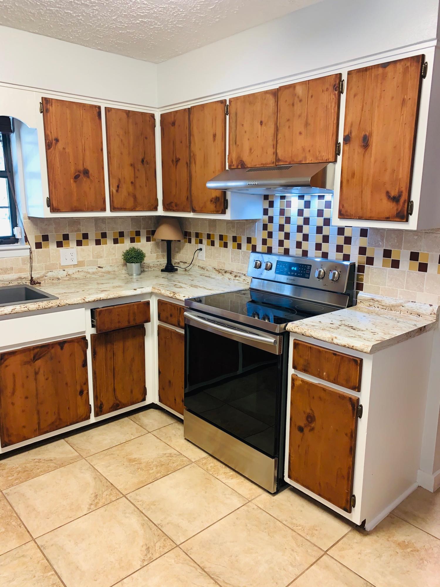5846 Dairy Road Baker, FL 32531 - Photo 18 of 68 a kitchen with a sink stove and cabinets