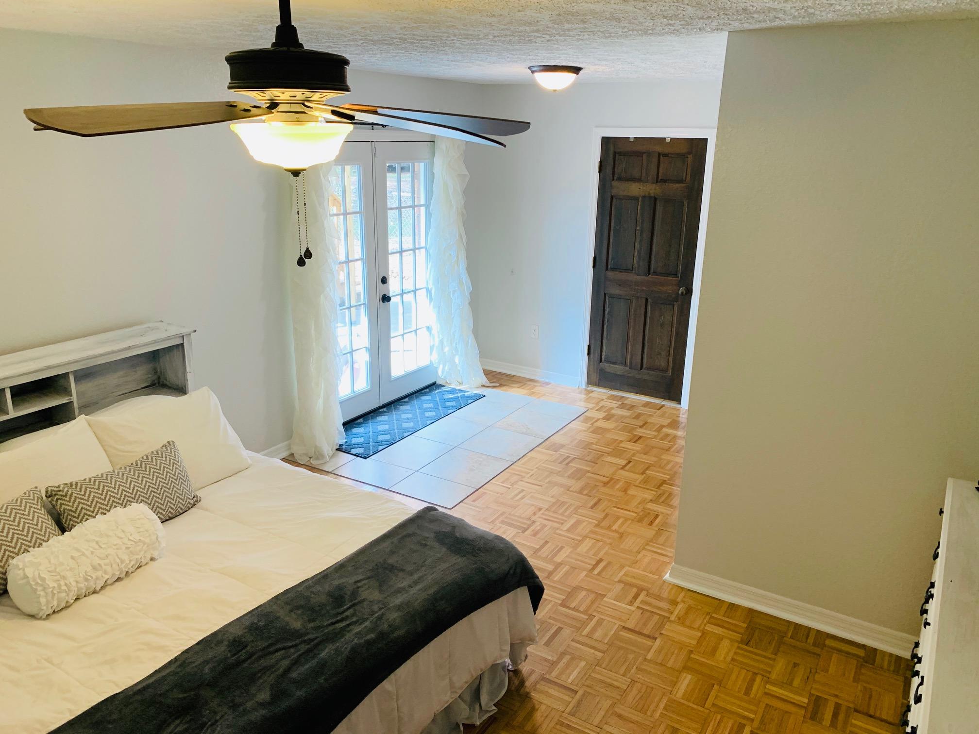 5846 Dairy Road Baker, FL 32531 - Photo 26 of 68 a bedroom with a bed and wooden floor
