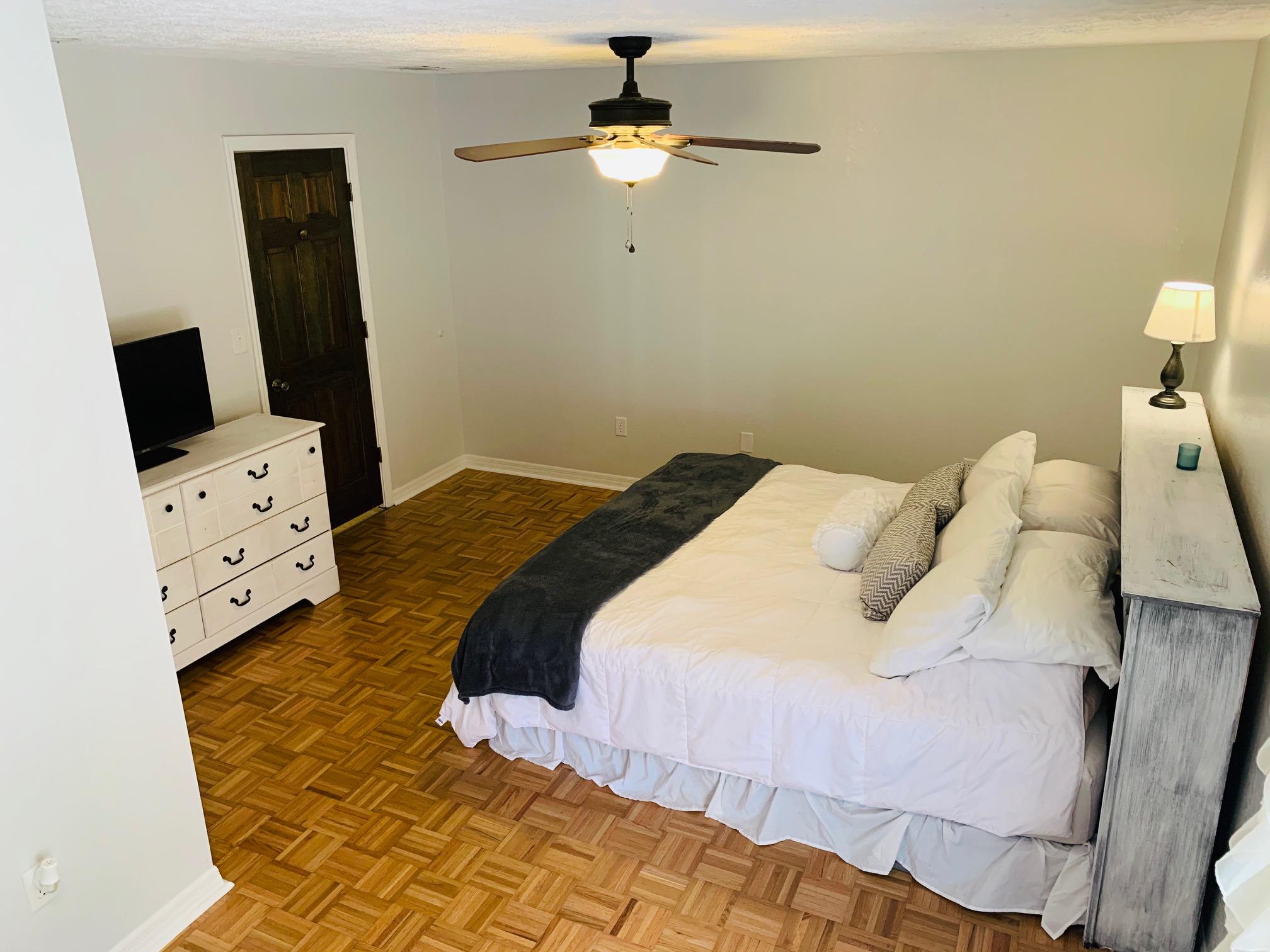 5846 Dairy Road Baker, FL 32531 - Photo 30 of 68 a bedroom with a bed and a flat tv screen on the dresser