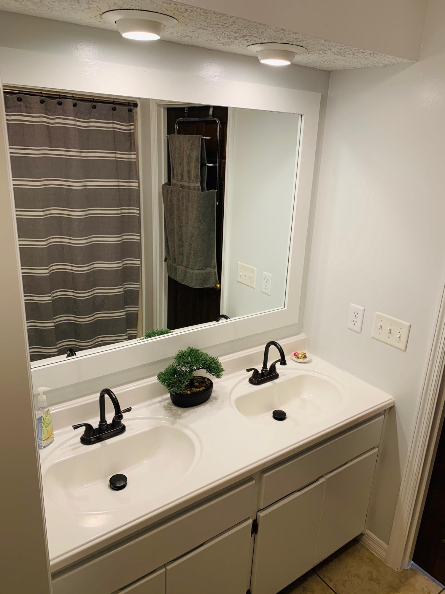 5846 Dairy Road Baker, FL 32531 - Photo 36 of 68 a bathroom with a sink and a mirror