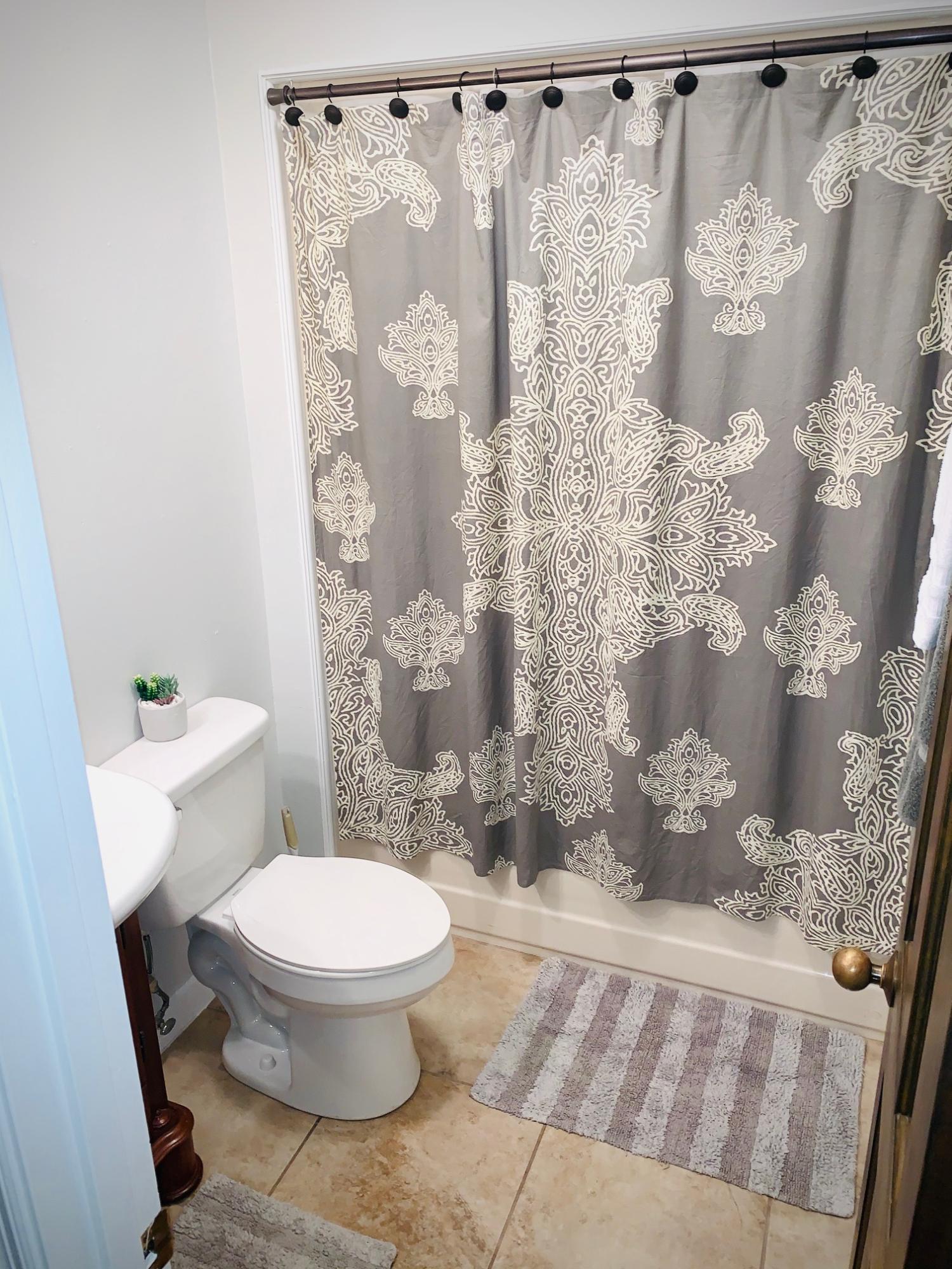 5846 Dairy Road Baker, FL 32531 - Photo 40 of 68 a white toilet sitting next to a shower curtain