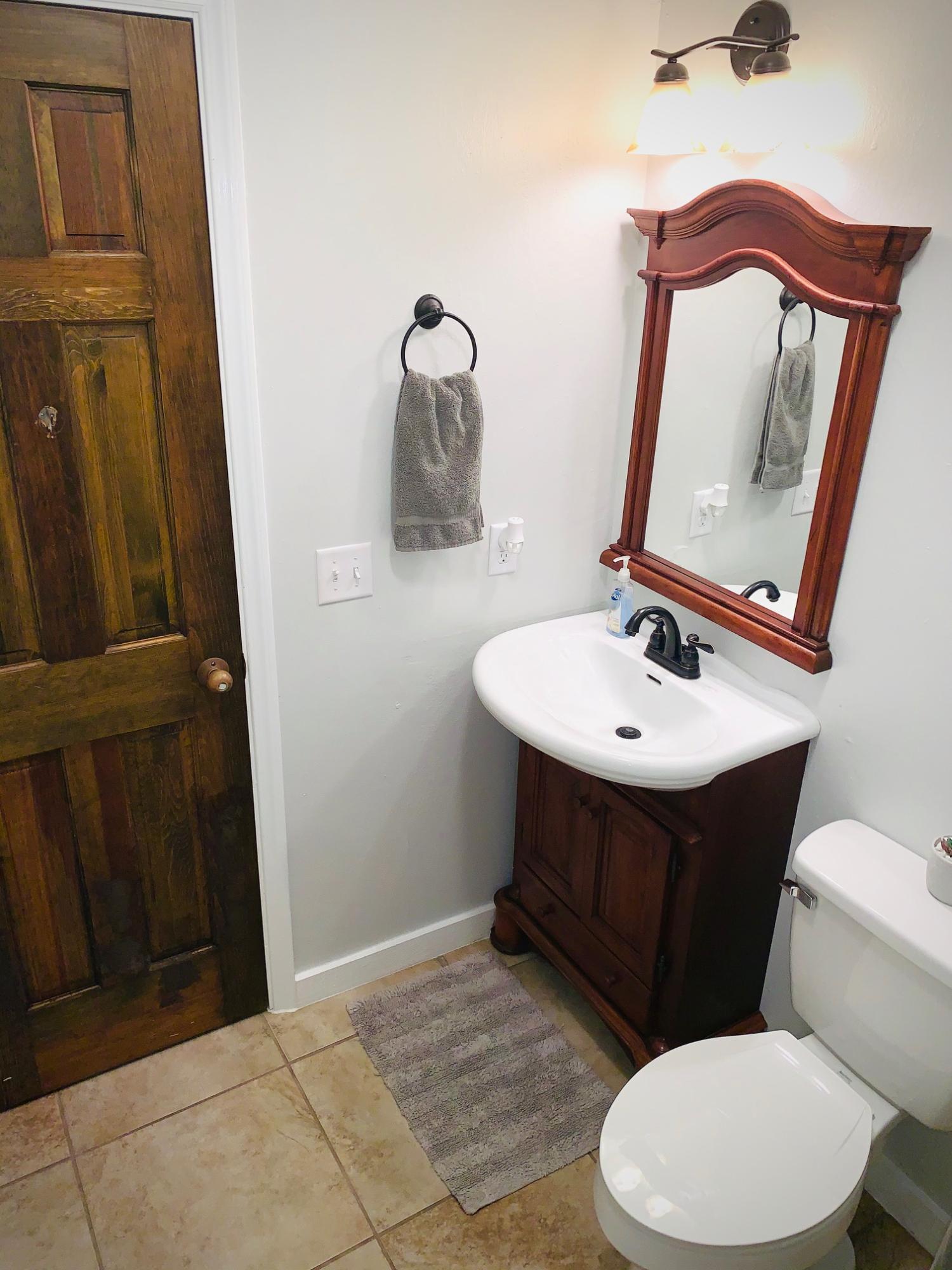 5846 Dairy Road Baker, FL 32531 - Photo 41 of 68 a bathroom with a toilet sink and mirror