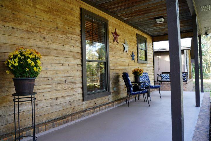5846 Dairy Road Baker, FL 32531 - Photo 6 of 68 a view of a porch with chairs and potted plants