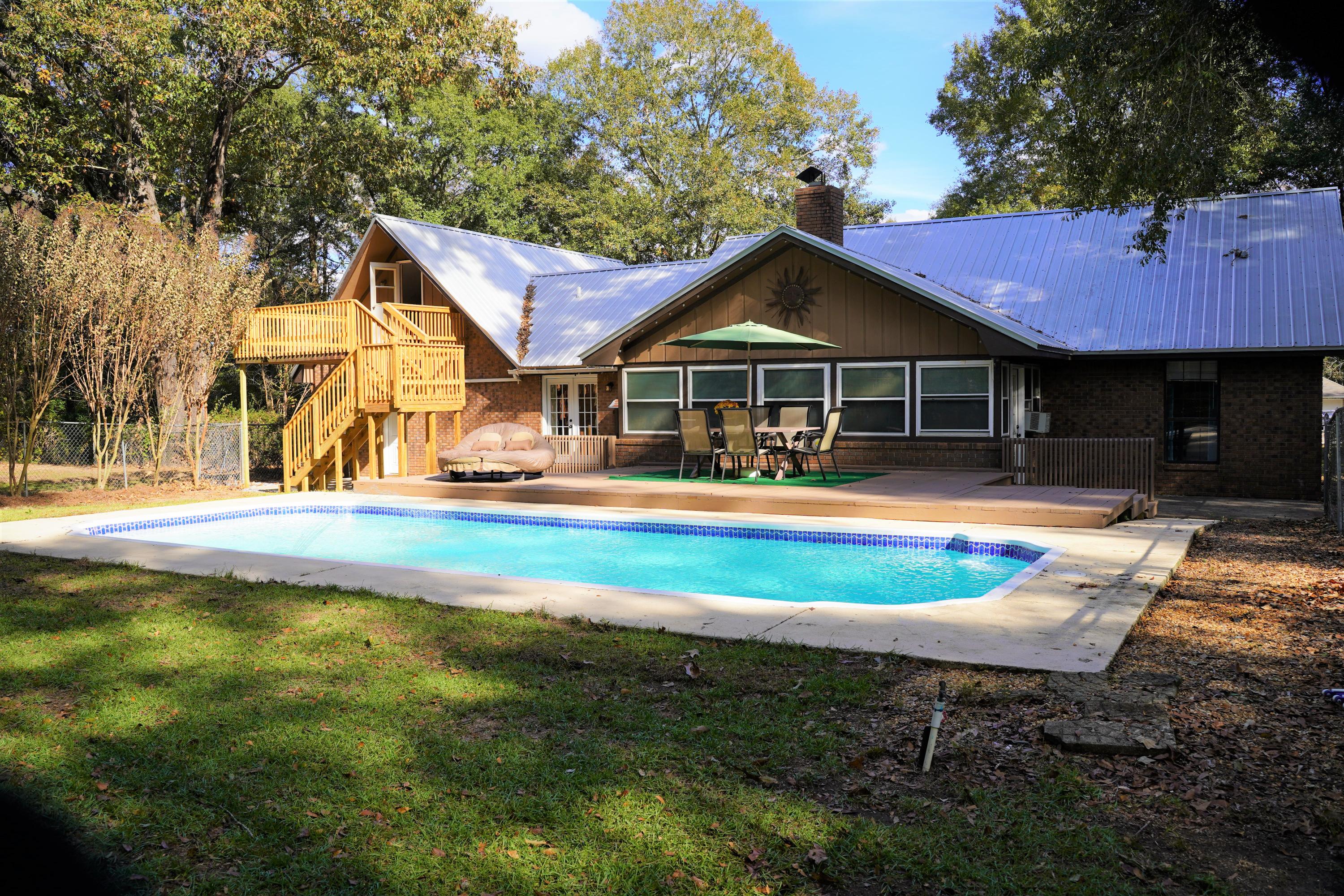 5846 Dairy Road Baker, FL 32531 - Photo 51 of 68 a view of a house with swimming pool and porch