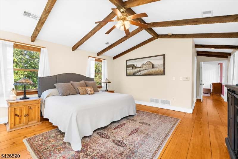 179 Lindbergh Road Hopewell, NJ 08525 - Photo 21 of 46 a bedroom with a bed and wooden floor