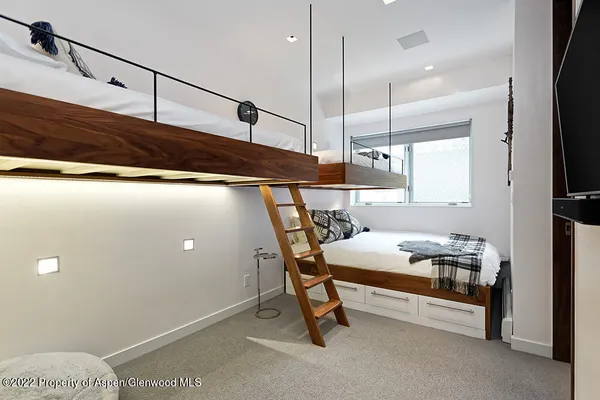 a bedroom with a bed and a tv