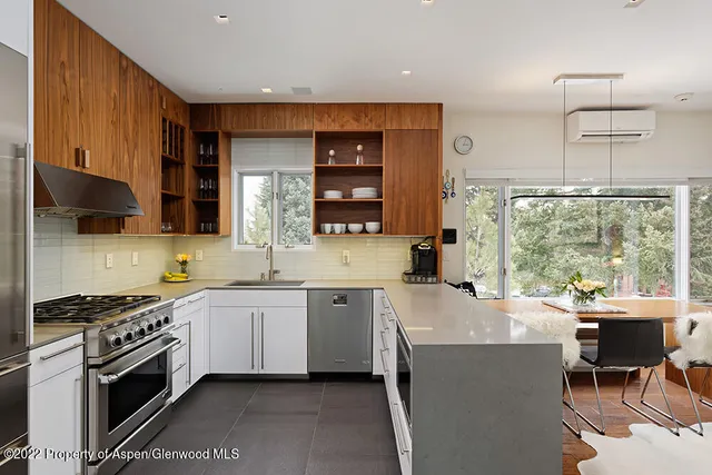 a kitchen with stainless steel appliances a sink stove and cabinets