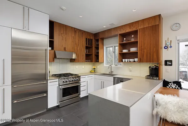 a kitchen with a sink stainless steel appliances and cabinets