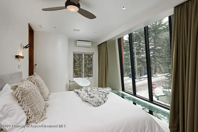 a bedroom with a large bed and a large window