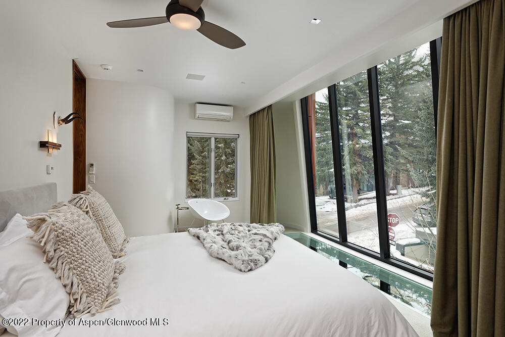 623 South Monarch Street, Unit C Aspen, CO 81611 - Photo 10 of 24 a bedroom with a large bed and a large window