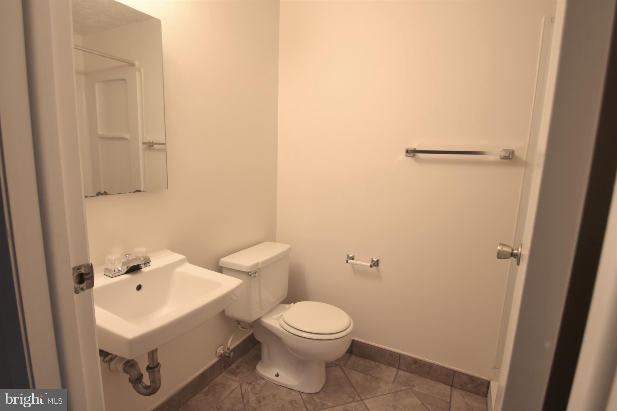 830 Heather Ridge Drive, Unit 22H Frederick, MD 21702 - Photo 10 of 14 a white toilet sitting next to a white sink