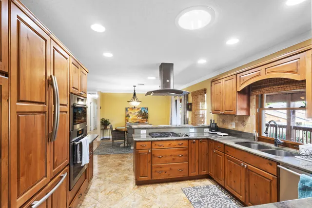 a kitchen with stainless steel appliances granite countertop a sink stove and refrigerator