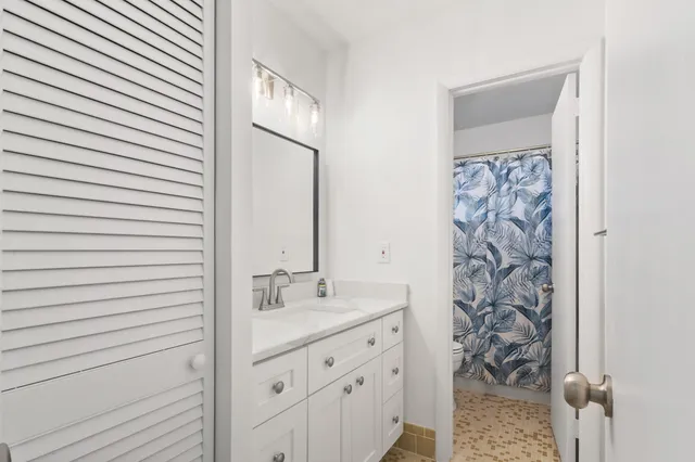 a bathroom with a shower and a sink