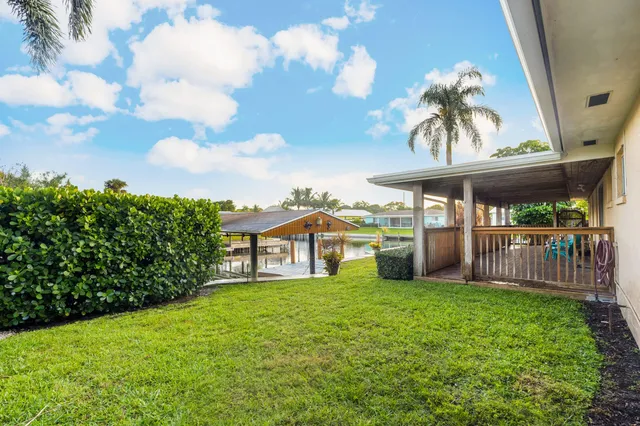 a view of a house with swimming pool and sitting area