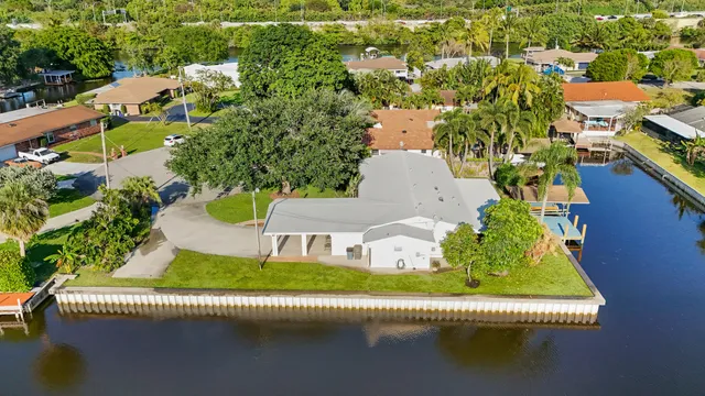 a view of a swimming pool with outdoor seating and plants