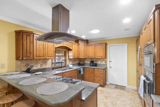 a kitchen with sink refrigerator and cabinets