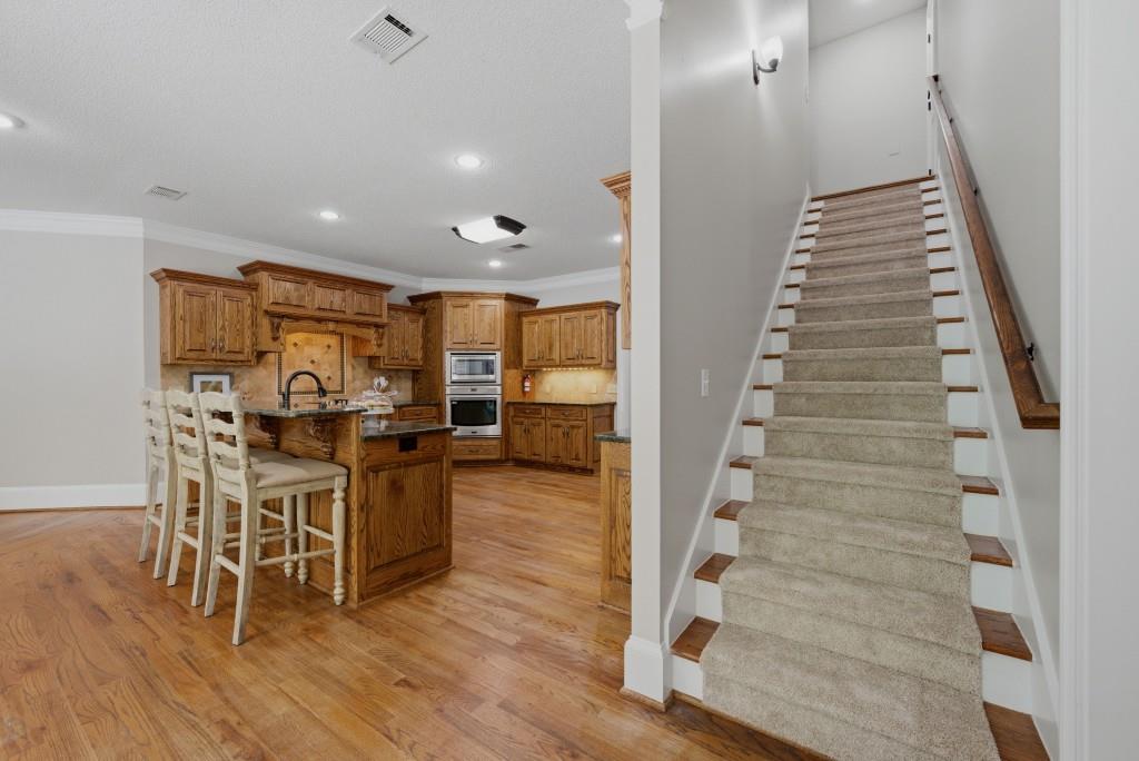 582 Knox Chapel Road Social Circle, GA 30025 - Photo 26 of 49 a view of a hallway with wooden floor electronic appliances and stairs