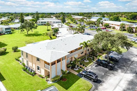 an aerial view of a house with swimming pool garden and lake view