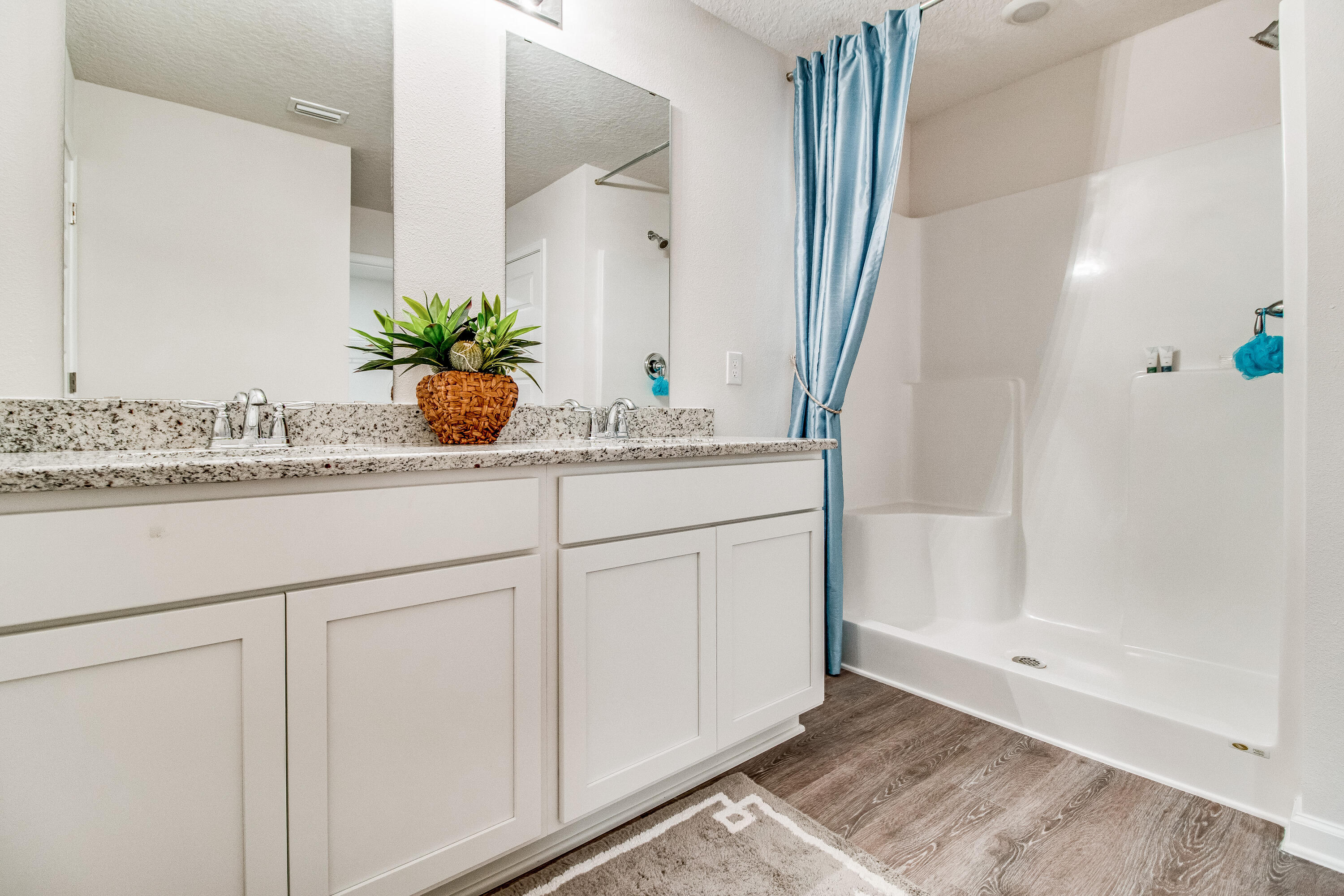 733 Quintana Street Crestview, FL 32539 - Photo 16 of 32 a bathroom with cabinets and mirror