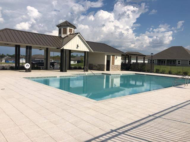 733 Quintana Street Crestview, FL 32539 - Photo 29 of 32 a view of a house with a swimming pool and a yard