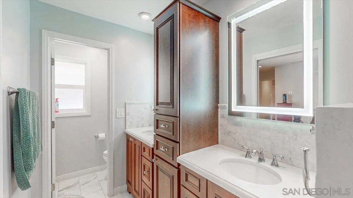 1525 Fair Glen Road El Cajon, CA 92019 - Photo 14 of 15 a bathroom with a sink a mirror and a shower