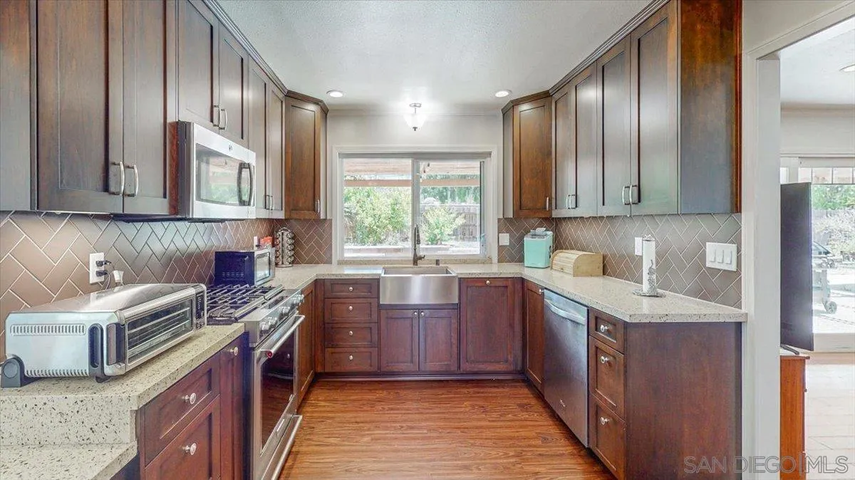1525 Fair Glen Road El Cajon, CA 92019 - Photo 5 of 15 a kitchen with a sink stove and cabinets
