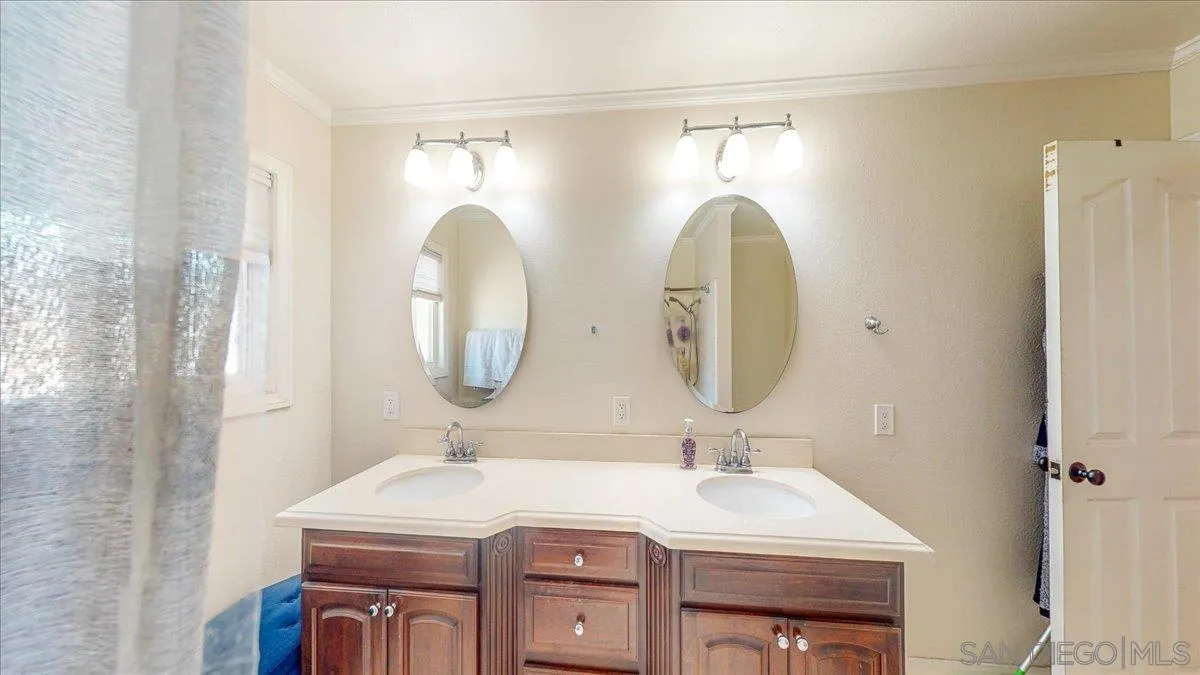 1525 Fair Glen Road El Cajon, CA 92019 - Photo 10 of 15 a bathroom with a sink and a mirror