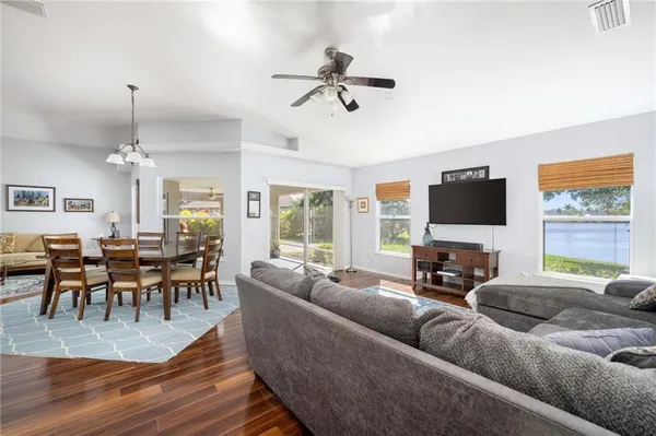 a living room with furniture wooden floor and a flat screen tv