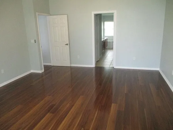 a view of wooden floor in an empty room