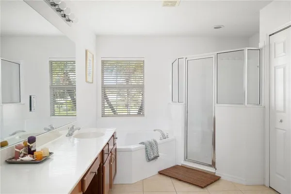 a bathroom with a tub sink and a shower