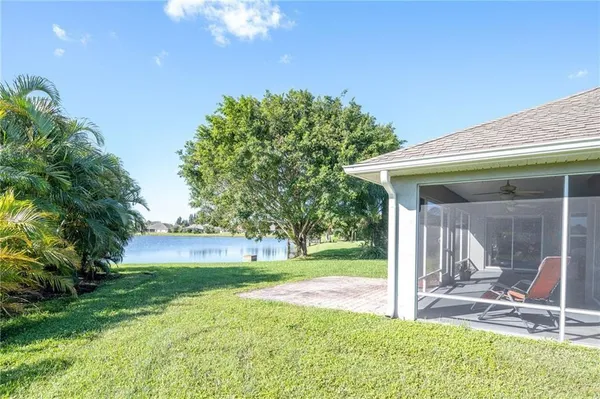 a view of a house with backyard and sitting area