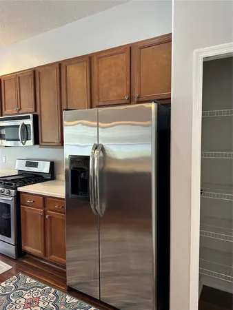 a kitchen with a refrigerator sink and cabinets