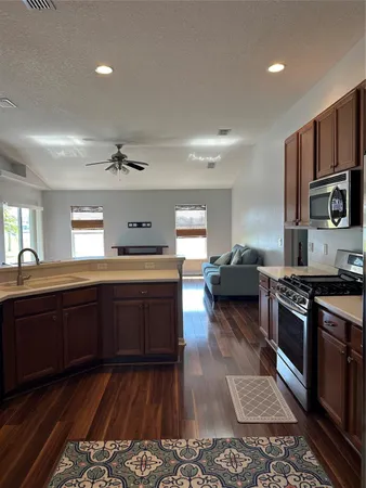 a kitchen with stainless steel appliances granite countertop a stove a sink and a refrigerator