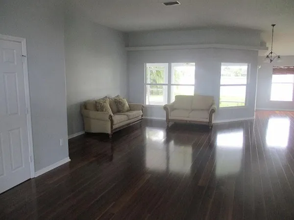 a living room with couches and a coffee table with wooden floor