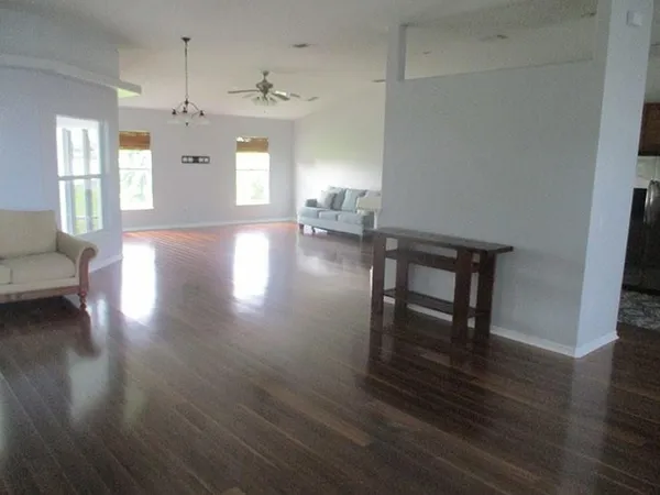 a view of a livingroom with furniture wooden floor and a window